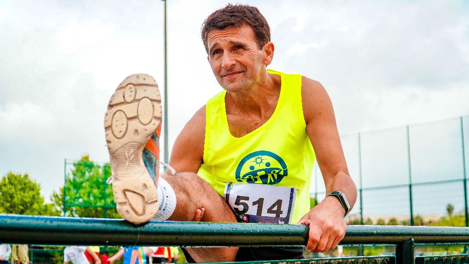 Runner stretching leg on handrail