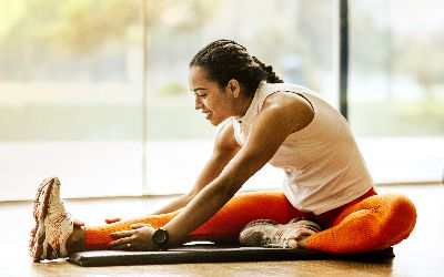 Woman stretching hamstring on floor