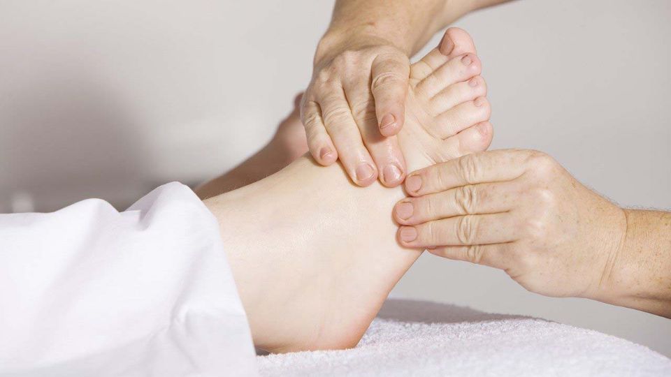 Physiotherapist working on injured foot