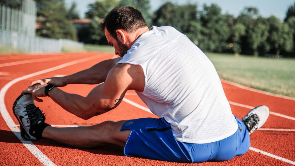 Runner stretching on the track