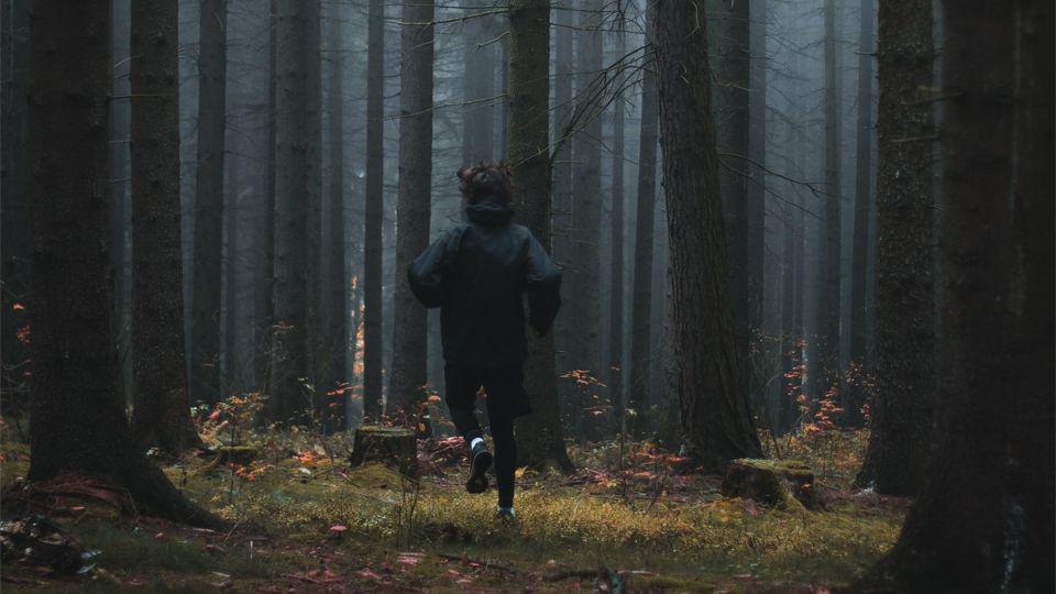 runner in a gloomy wood