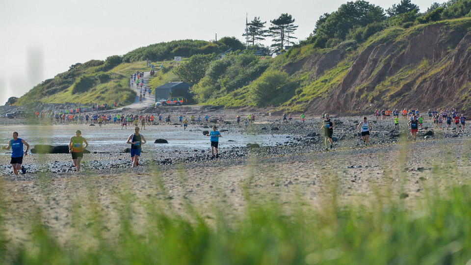 runners on the beach at Tour of Merseyside