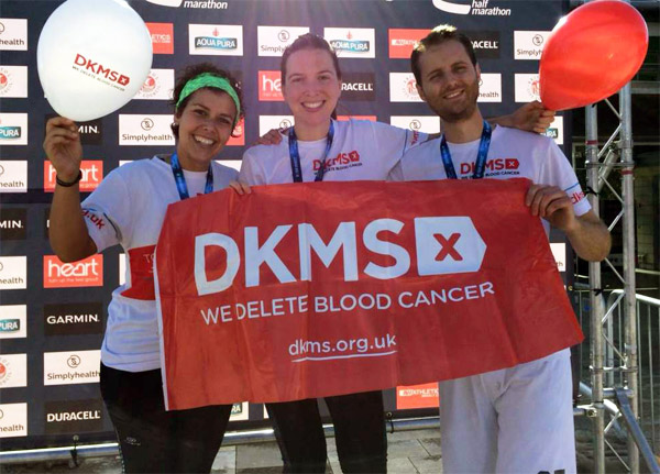 Three happy runners in DKMS vests