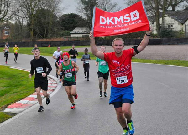 runner in DKMS T-shirt with flag