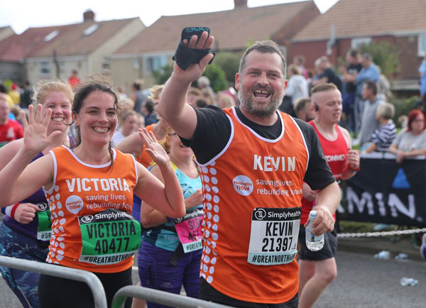Happy runners in Meningitis Now vests at Great North Run