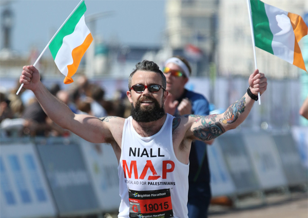 Man running in MAP vest with irish flags