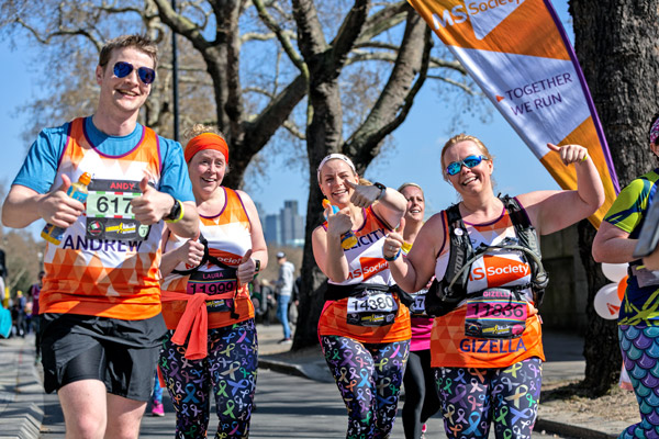 Happy runners in MS vests