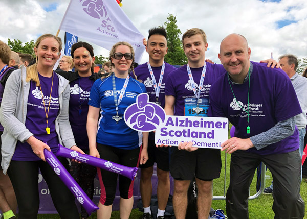 Happy group pose after marathon run