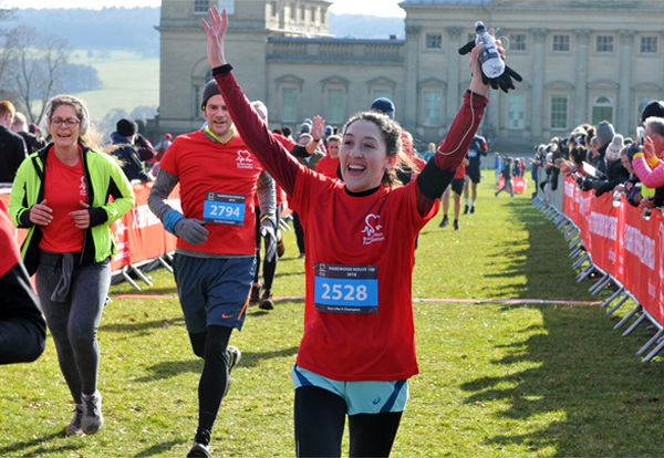 Happy woman finisher in front of Harewood House