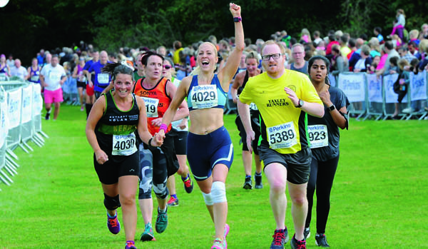 Triumphant runner with raised arm at The Great Eastern Run