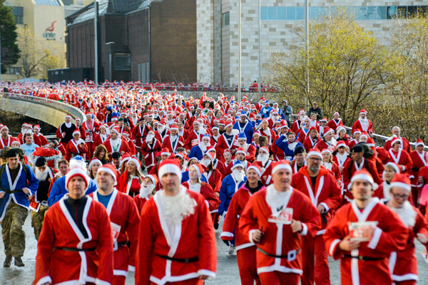 a sea of red and blue Santas