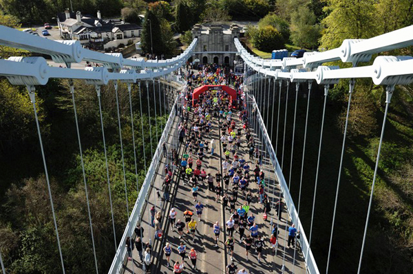 bird's eye shot of runners on the bridge at Anglesey Half