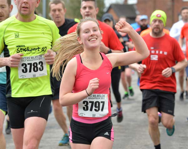 Girl runner with raised arm salute at Wilmslow Half