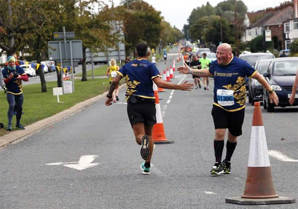 runners enjoy a friendly hand slap at Hull Marathon