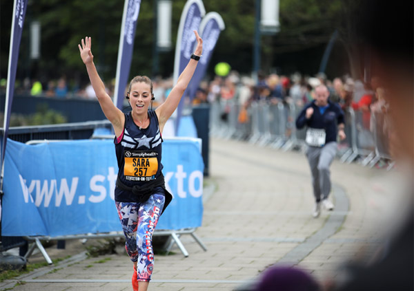Arms raised girl runner at the Great City Games