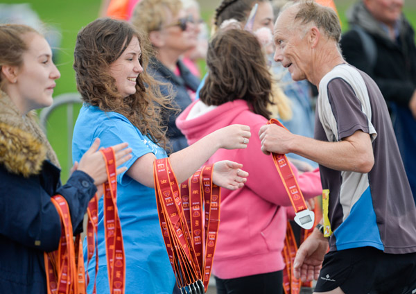 runners collecting medals after BTR race