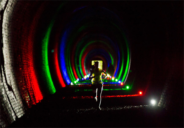 runnes in colour light filled tunnel