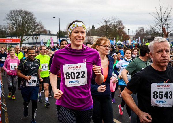 Smiley runner in purple vest at Surrey Half