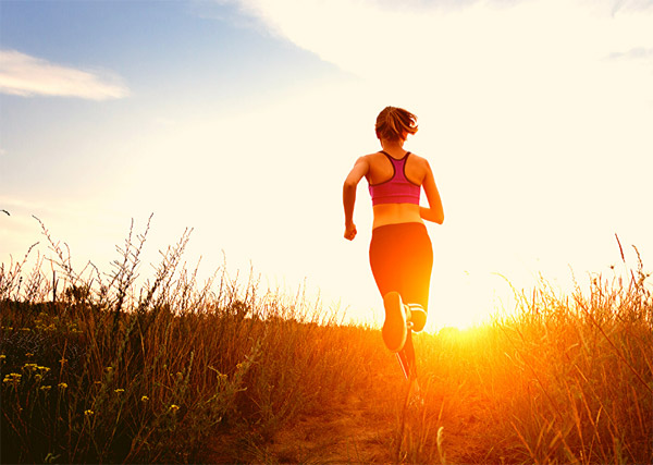 Woman runs into the sunset