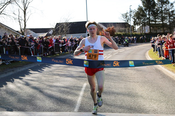 Callum Symonds breaking the tape at Run Garioch 10K