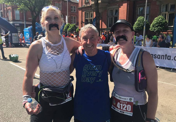 Two runners dressed up as Ron Hill at the 2018 Hyde 7 pictured with Dr Ron