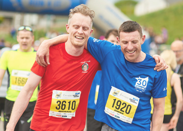 two happy runners after finishing the BHGE 10K
