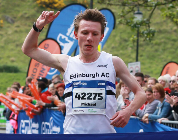 Michael Christoforou breaks the tape to win the race