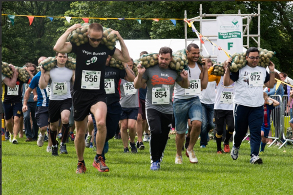 Man carrying a sack of potatoes in a race
