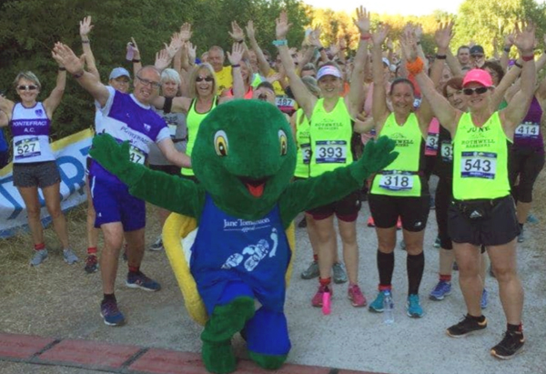 A group of bouncy runners pose for a shot