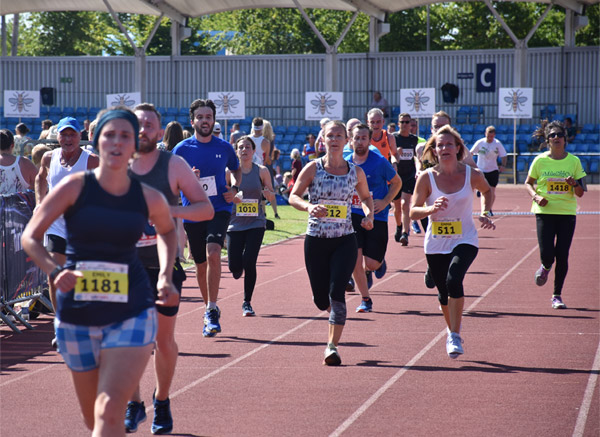 runners on the track at City of Man 10K