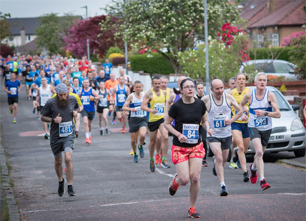 runners on tree-lined street at Helensburgh 10K