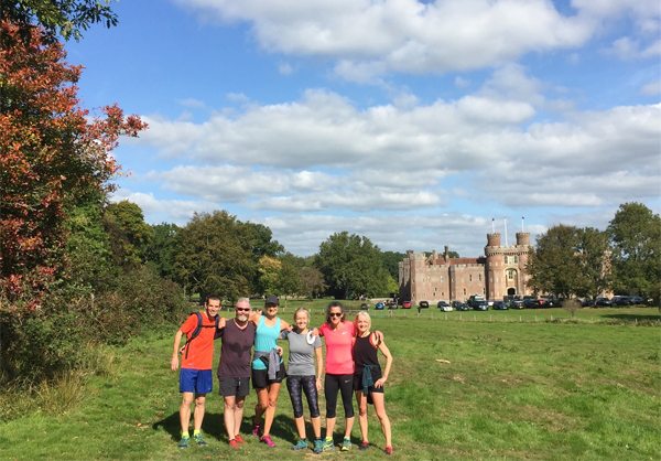 runner group pose with castle backdrop