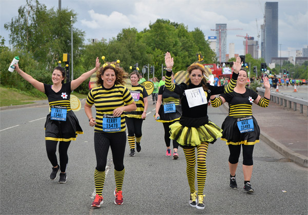Runners in bee outfits