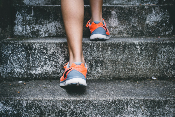 runner climbing steps