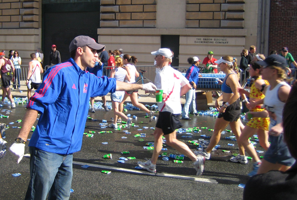 Volunteer handing out paper cups at Boston Marathon