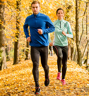 runners moving elegantly through woodland