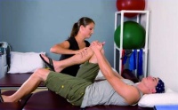 A physiotherapist giving treatment to a man